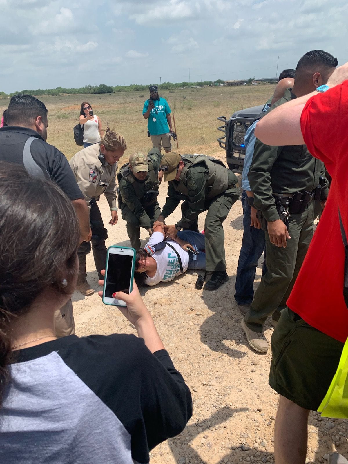 Dimmit County sheriff's deputies arrest a protester at the Carrizo Springs migrant children...