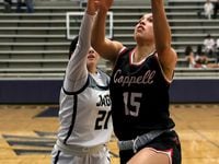 Coppell guard Atia Medenica (15) goes strong to the basket against Flower Mound guard...