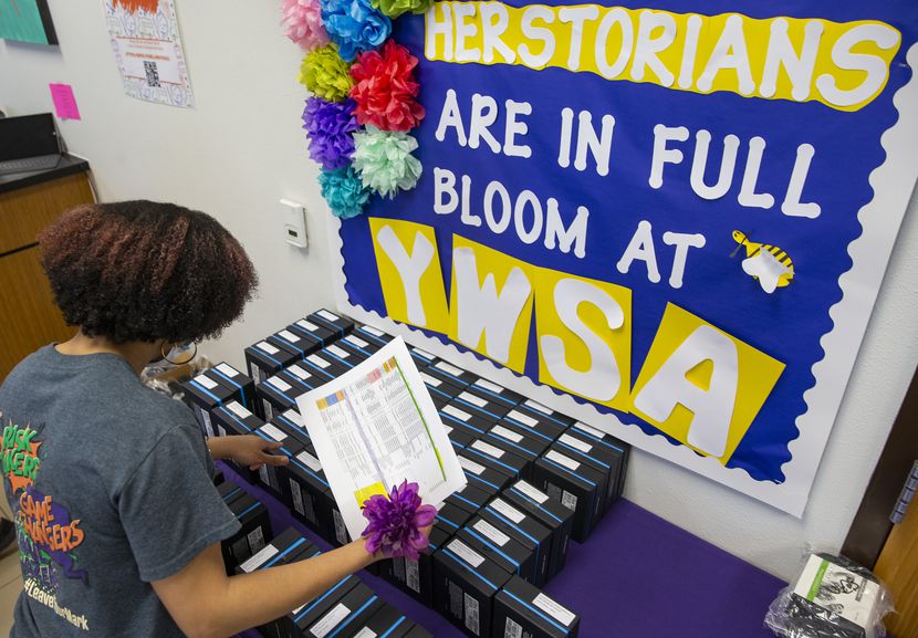 Principal Gabrelle Dickson grabs a Wi-Fi hotspot provided by DISD for a student at Young...