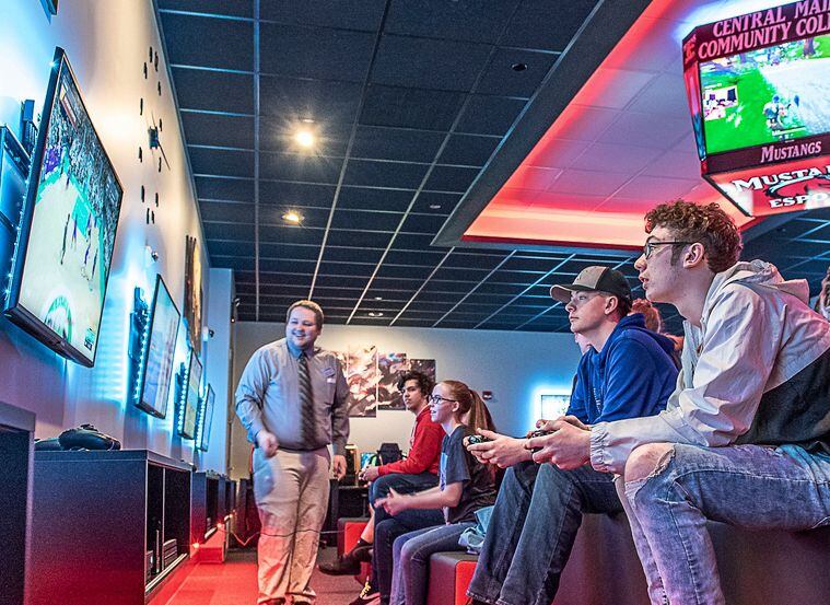 Gamers play at an esports arena open house.