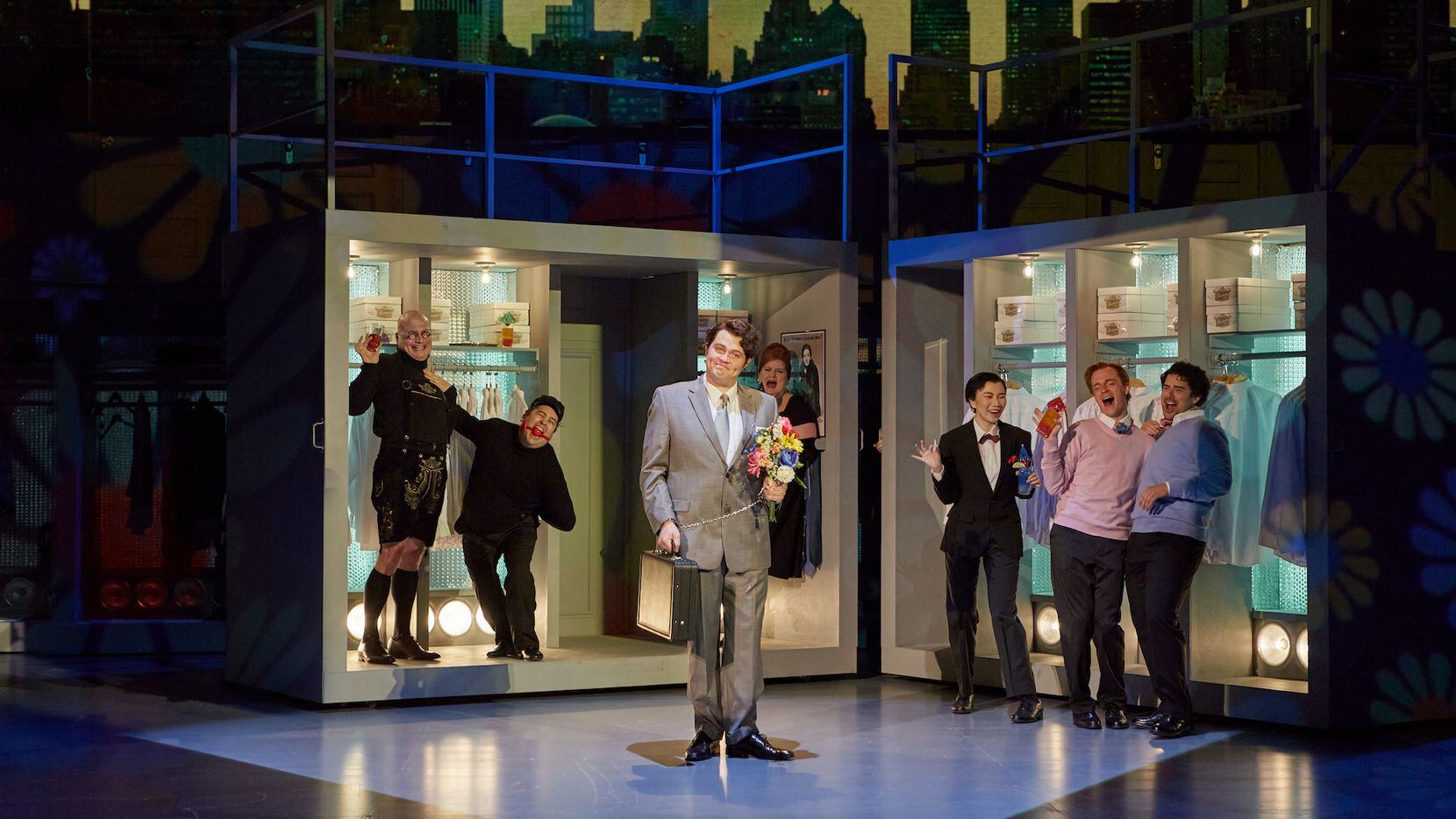 Thomas Glass, foreground, portrays Harvey Milk, with partiers, in the 2022 Opera Theatre of...
