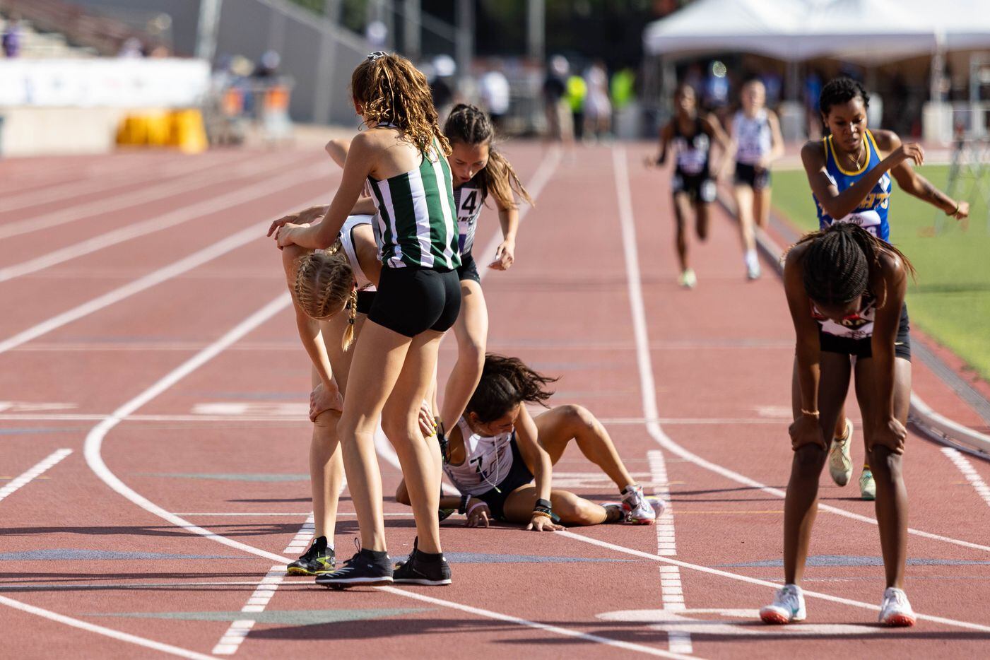 Kailey Littlefield of Lucas Lovejoy, left, catches her breath after winning the girls’ 800m...