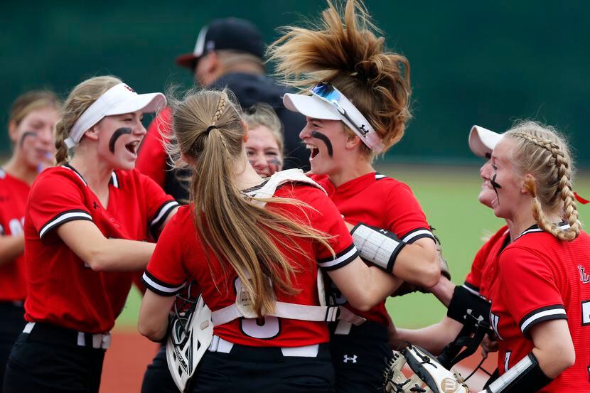 Lovejoy players celebrate with shortstop Skylar Rucker (center) after she tagged out a...
