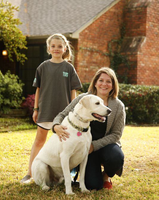 Dallas residents Addison Higgins (left), 9, and her mother, Amy, with their dog, Wrigley,...