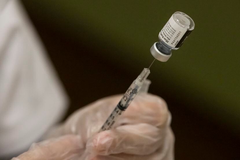 A Walgreens pharmacist prepared doses of the Pfizer vaccine to administer to residents of...