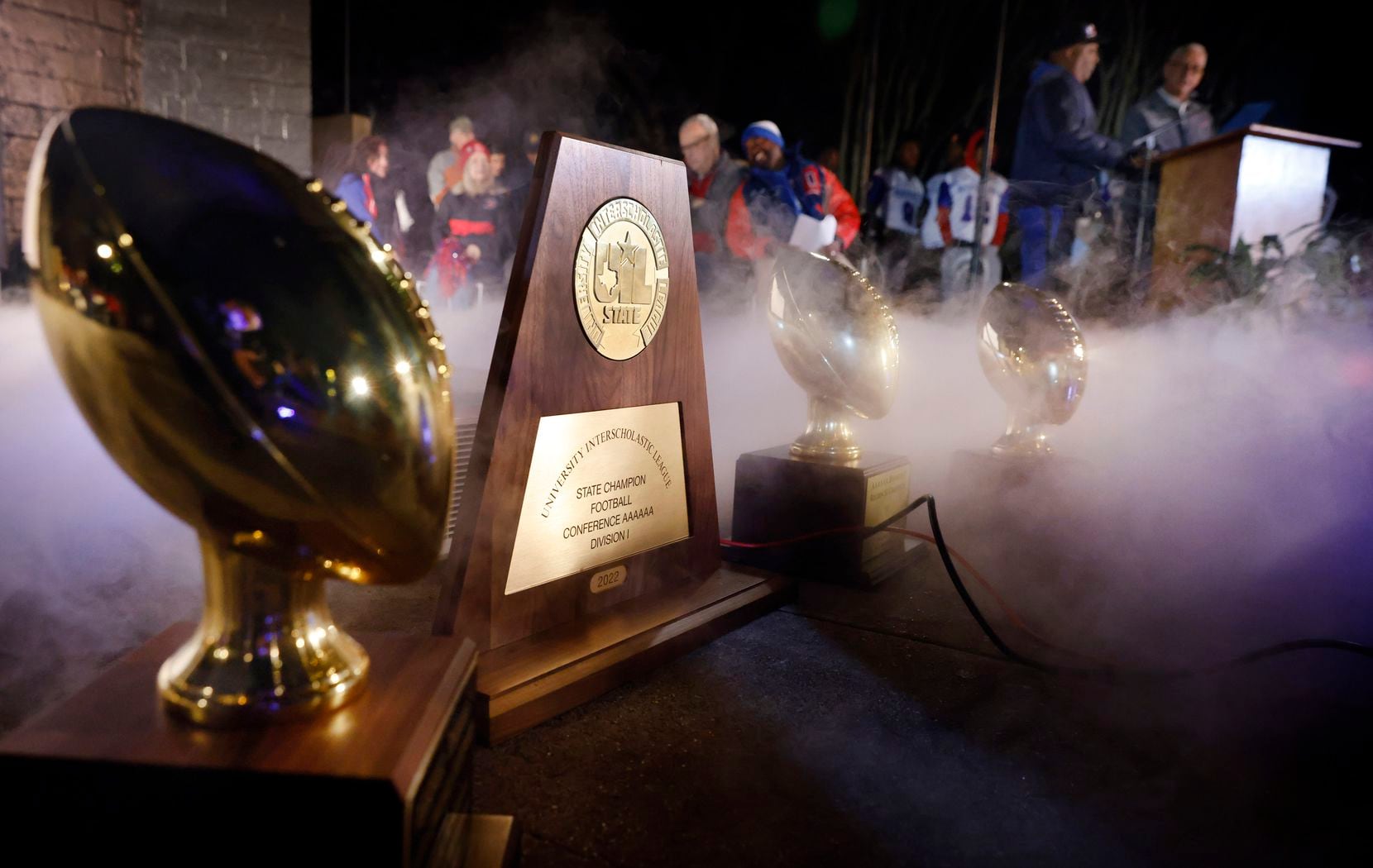 Artificial fog gathers around the trophies earned on the way to the 2022 6A Division I...