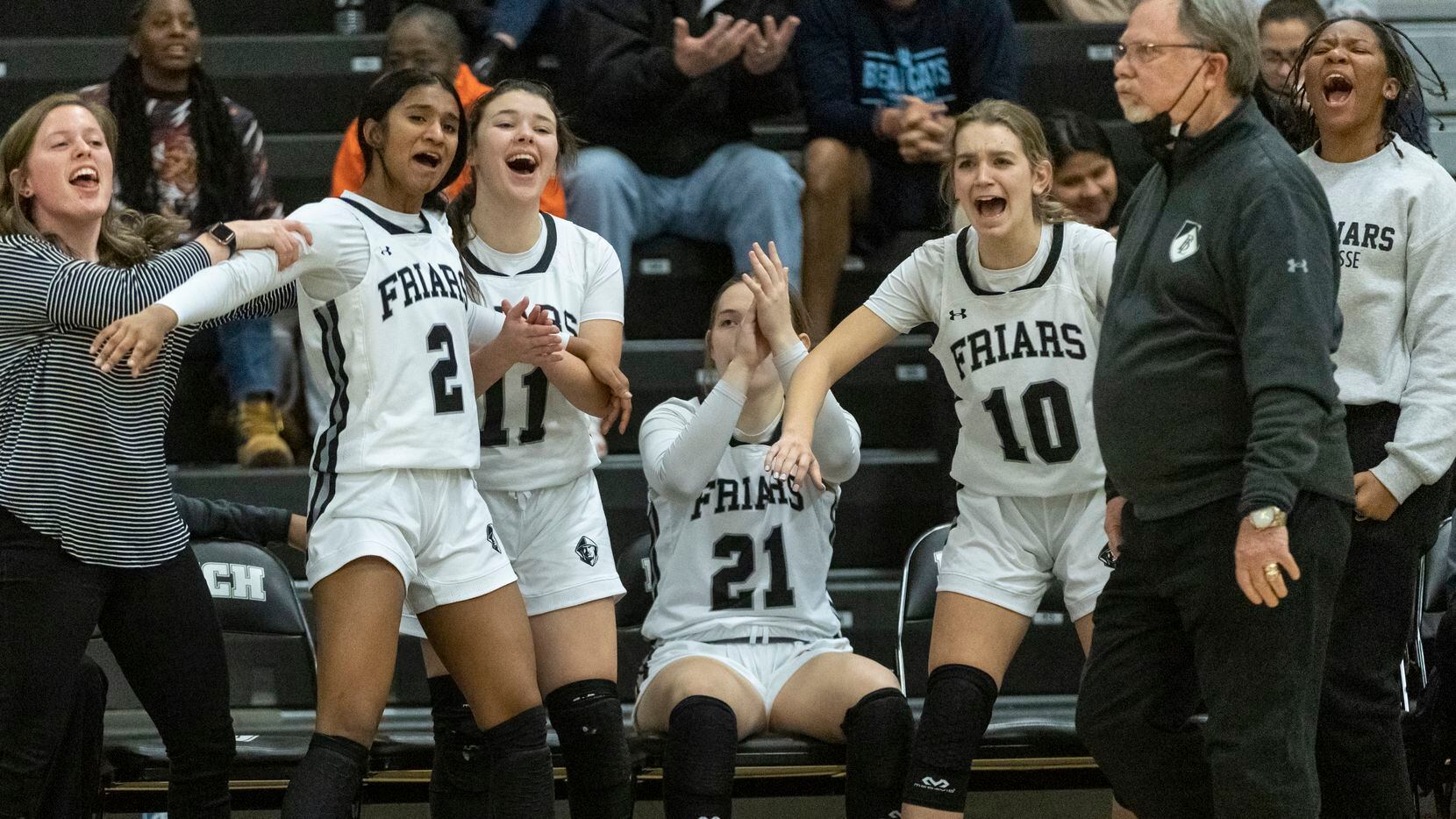 Bishop Lynch High School players celebrate as their teammates score in the fourth quarter...