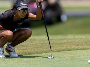 Hebron’s Symran Shah studies her shot on the 9th green during the 6A girls state golf...