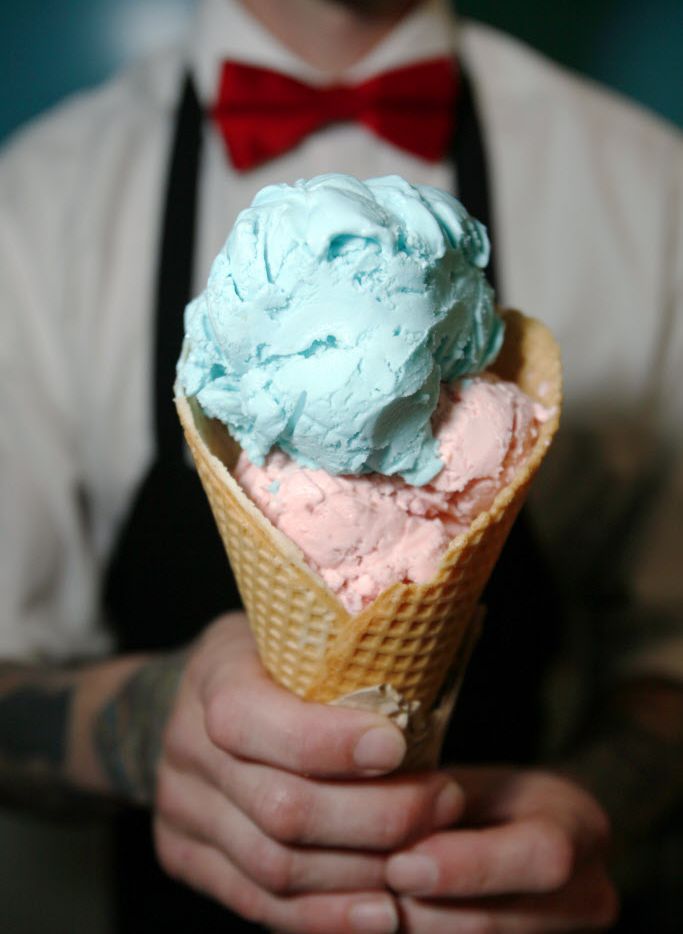 Brandon Cox holds a waffle cone with scoops of strawberry and bubble gum at Hypnotic Emporium, now open in East Dallas.