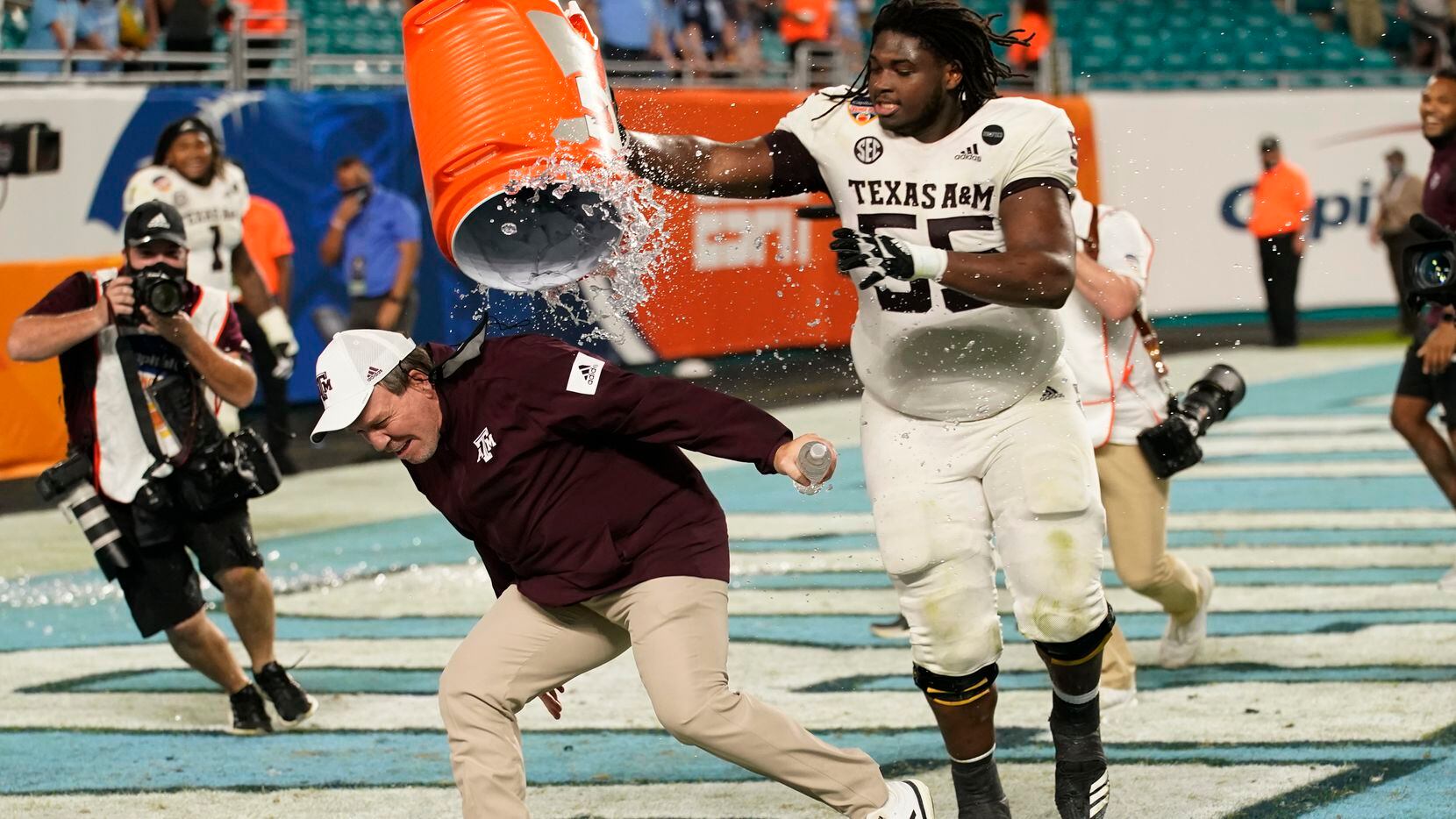 Texas A&M offensive lineman Kenyon Green (55) douses head coach Jimbo Fisher at the end of...