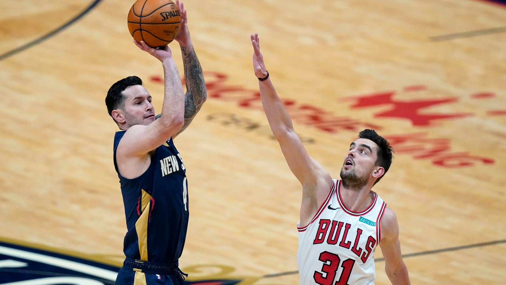 Pelicans guard JJ Redick shoots over Bulls guard Tomas Satoransky (31) during the first half of a game in New Orleans on Wednesday, March 3, 2021. (AP Photo/Gerald Herbert)