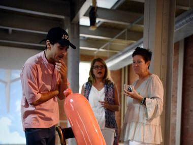 Artist Gabriel Rico speaks to Danielle Dupuis, left, and Liz Curlin, about his piece of art...