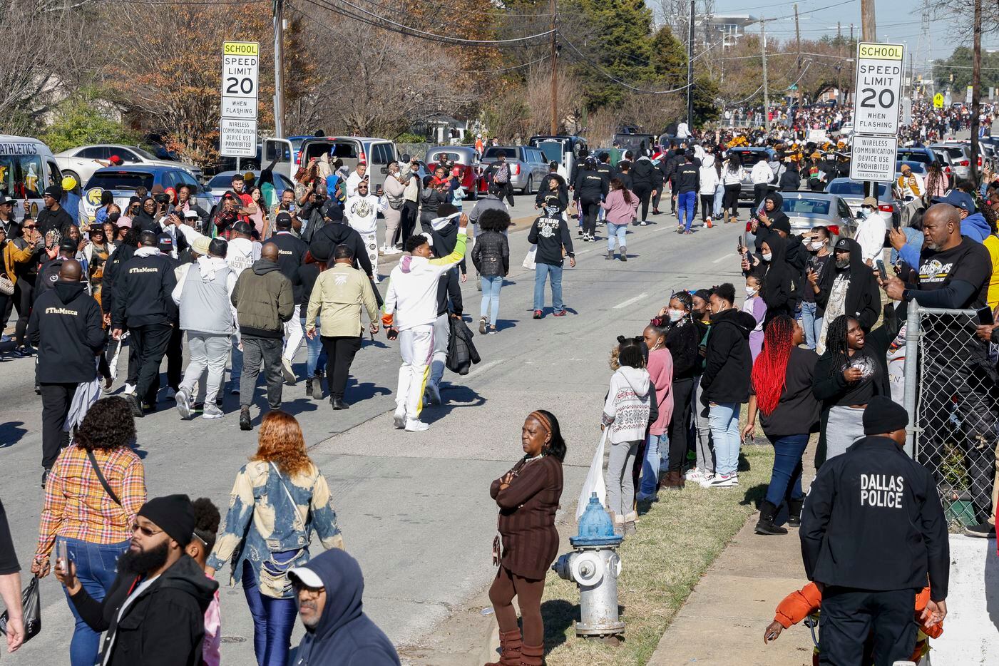 Community members and fans of South Oak Cliff line Marsalis Avenue during a parade...