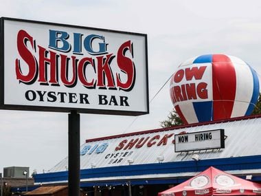 A "Now Hiring" sign at Big Shucks Oyster Bar in Dallas reflects the difficulty finding workers today. Employers are planning to pay bigger salaries next year, too.
