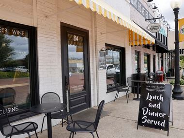 Tables and chairs line the outside of Toasted Walnut Table and Market in the Celina town...