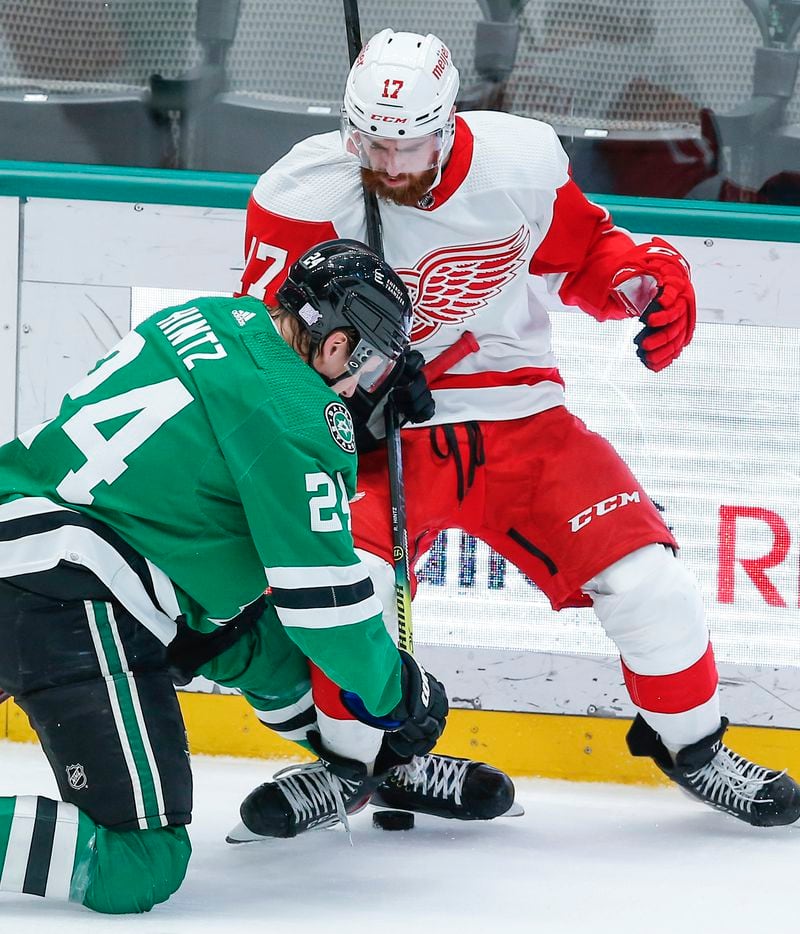 Dallas Stars forward Roope Hintz (24) battles Detroit Red Wings defenseman Filip Hronek (17) for the puck during the first period of an NHL hockey game, Tuesday, November 16, 2021. (Brandon Wade/Special Contributor)