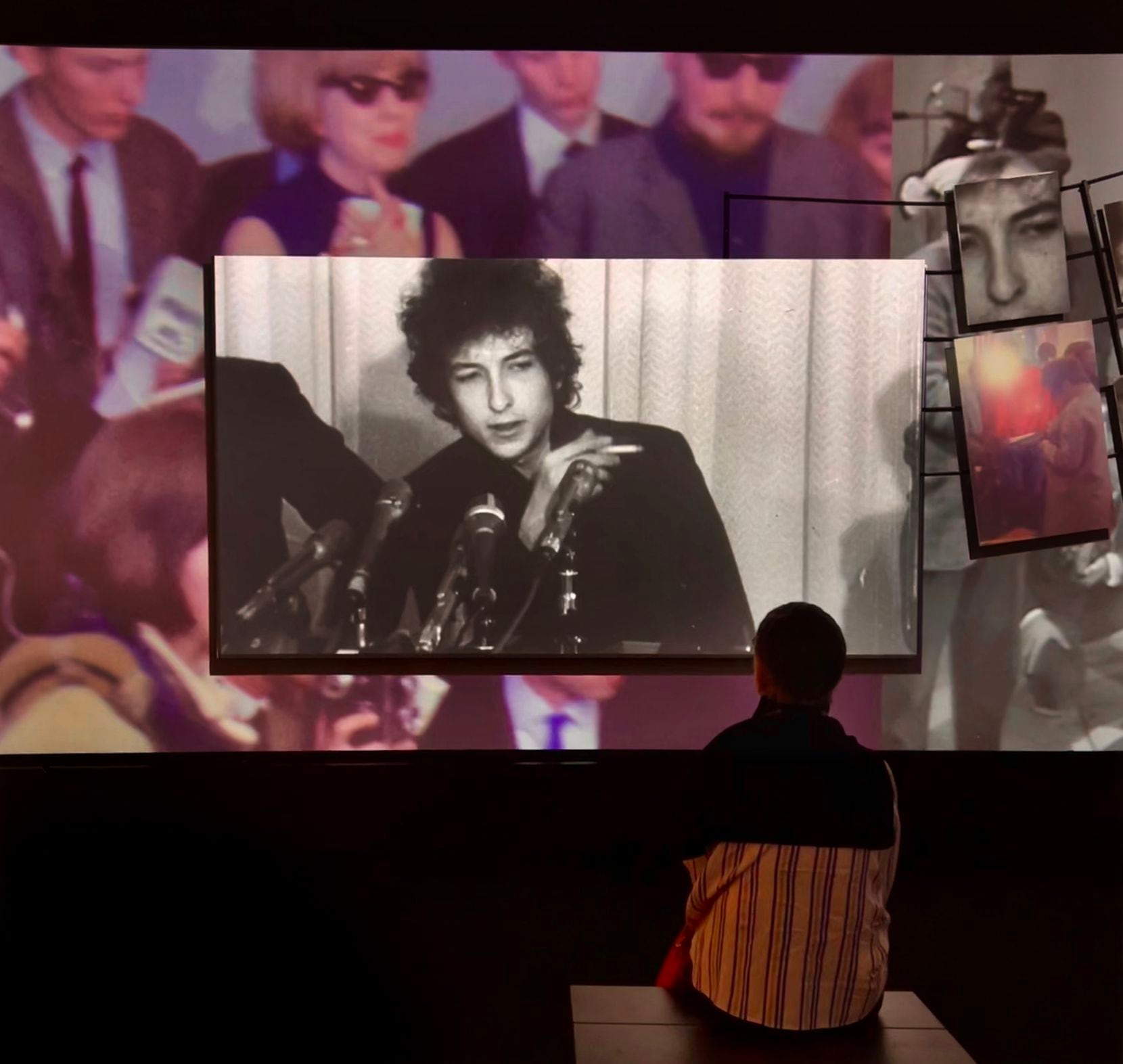A visitor watches archival footage of Bob Dylan at the singer's new museum in Tulsa.