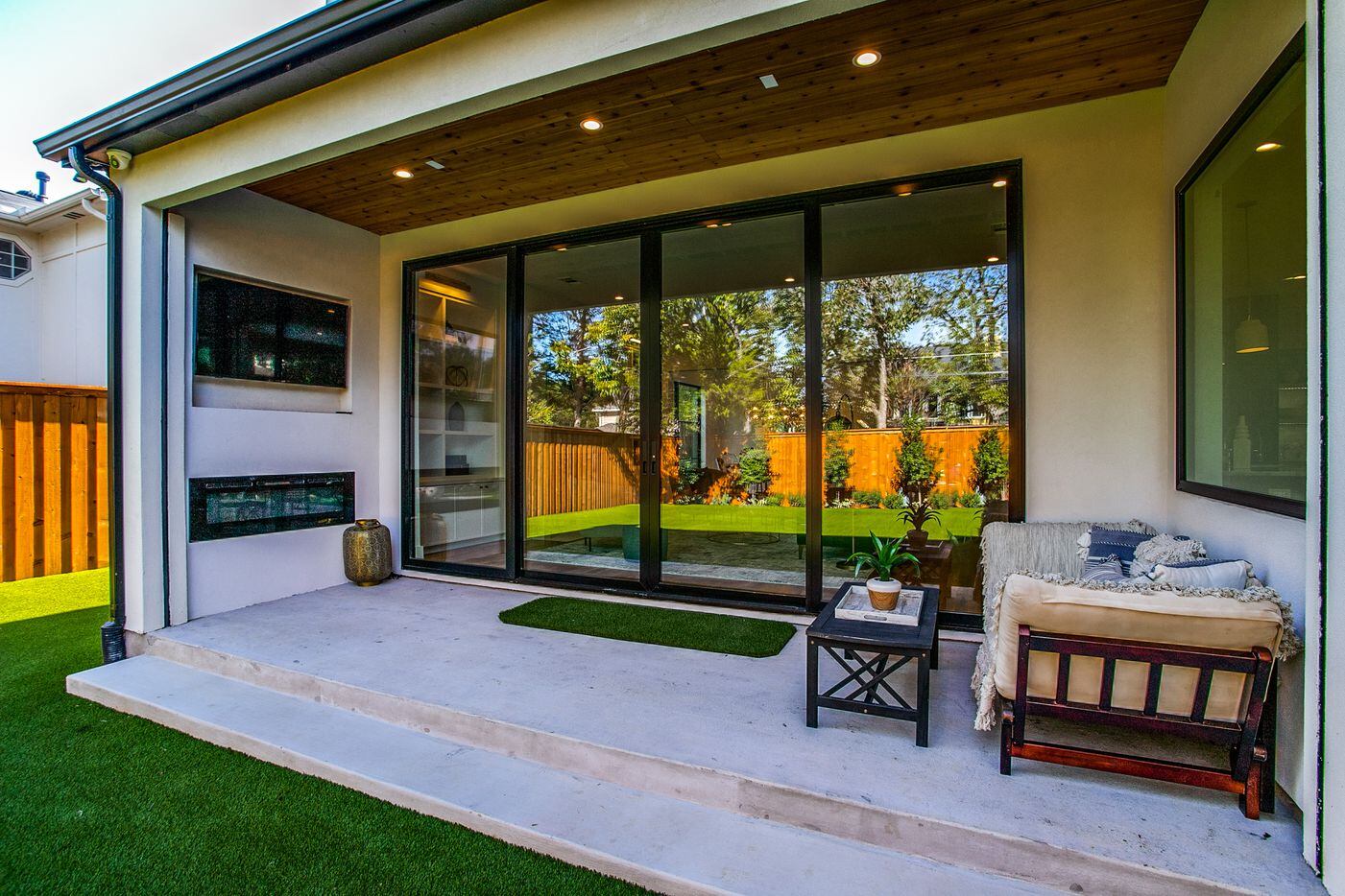One of two covered patios features an outdoor television and a fireplace.