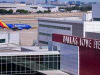 A Southwest Airlines flight taxis to the terminal at Dallas Love Field.