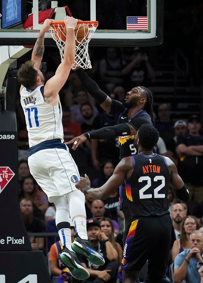 Dallas Mavericks guard Luka Doncic (77) dunks the ball past Phoenix Suns forward Jae Crowder...
