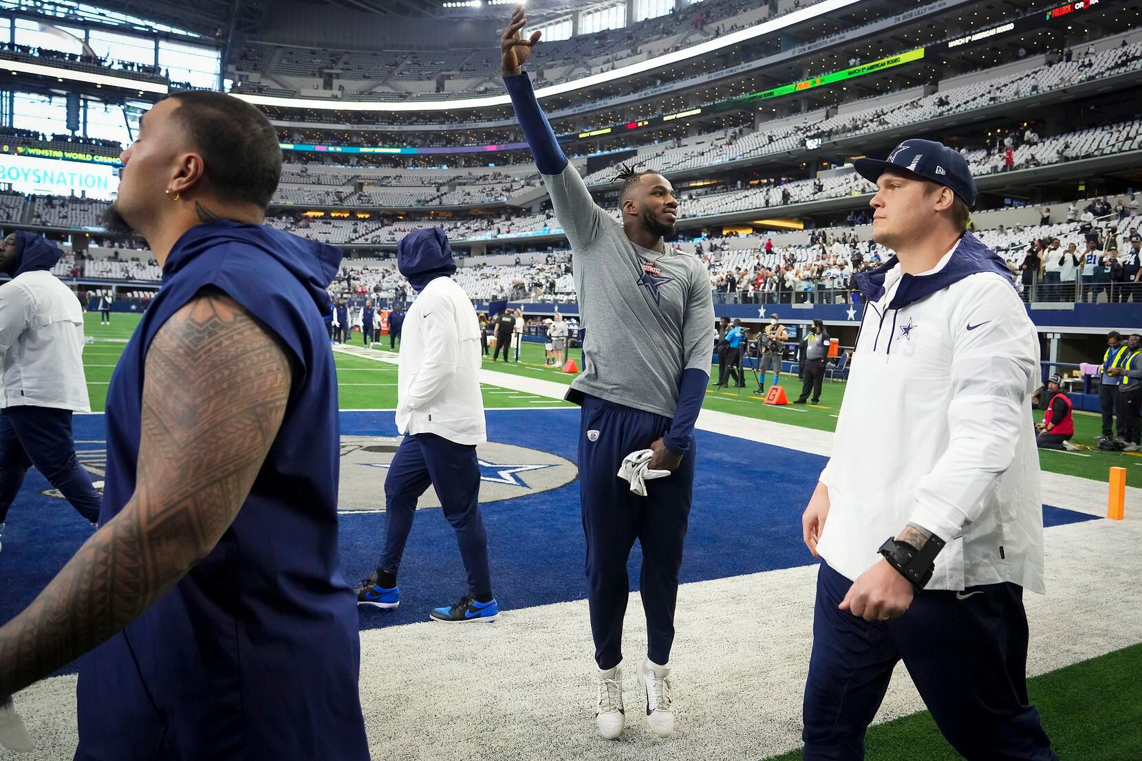 Dallas Cowboys defensive end Tarell Basham motions to the crowd as the teams take the field...