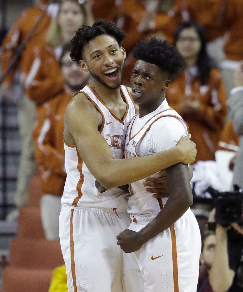 Texas center James Banks (4) celebrates a sore by guard Andrew Jones, right, during the...