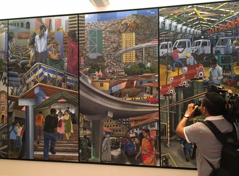A mural in the foyer of Mahindra Group headquarters fascinates Noe Cumplido, Gov. Greg...