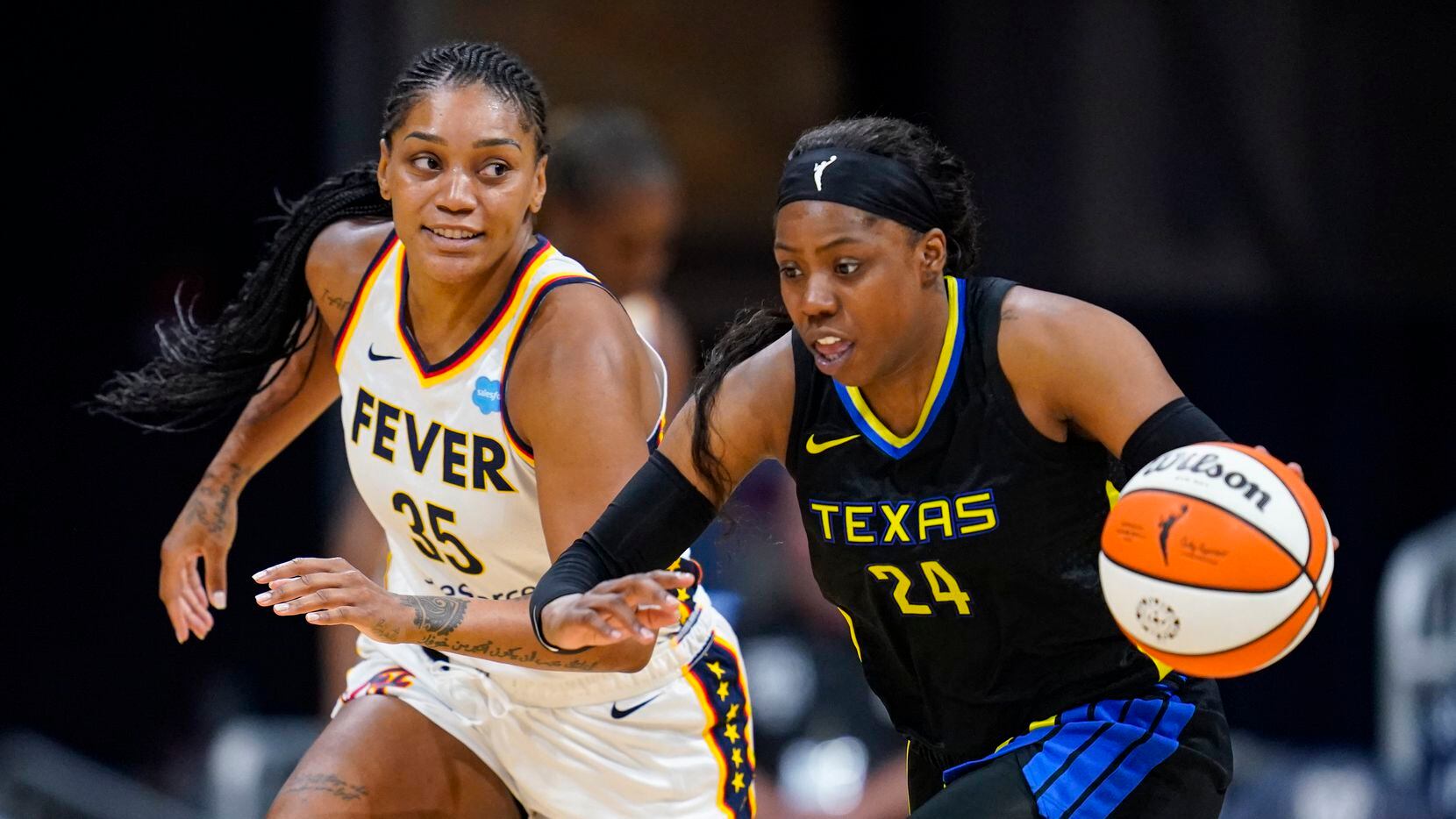 Dallas Wings guard Arike Ogunbowale (24) heads up count in front of Indiana Fever guard...