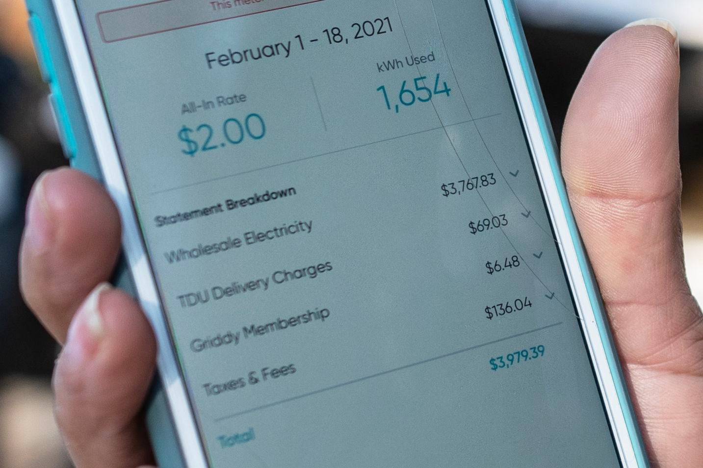 Ivet Cantu, 45, shows her electricity bill from Griddy energy on an app totaling $3,979.39...