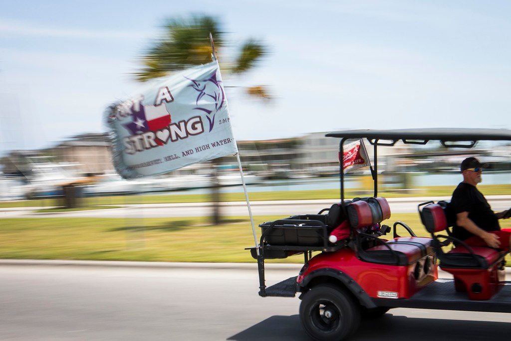 A "Port A Strong" flag flies behind a golf cart rolling through Roberts Beach Park in Port...