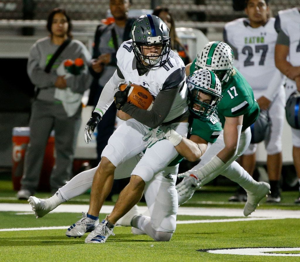 Southlake Carroll's James Miscoll (20) tackles Eaton's Kenneth Greene (17) during the first...