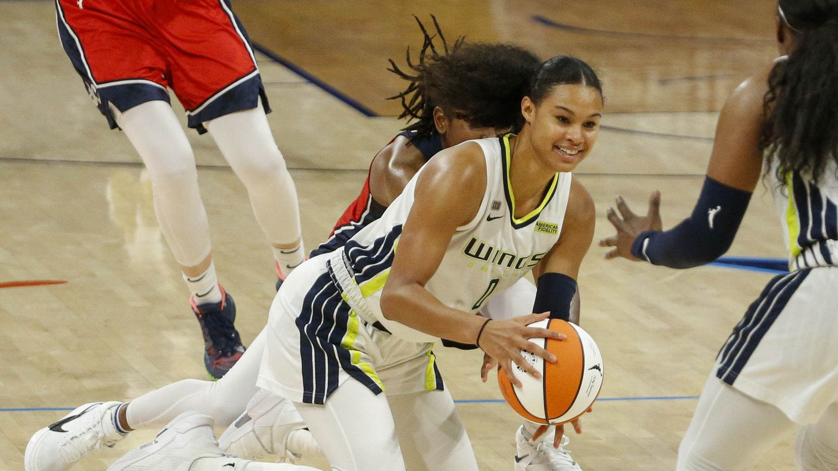 Dallas Wings forward Satou Sabally (0) dives to the floor for a loose ball during the fourth...