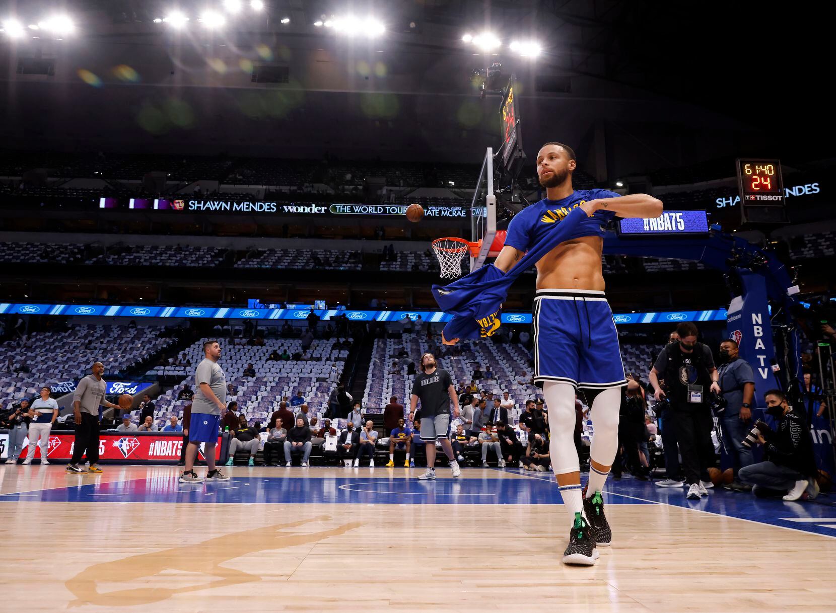 Golden State Warriors guard Stephen Curry (30) removes his shirt during warmups before...
