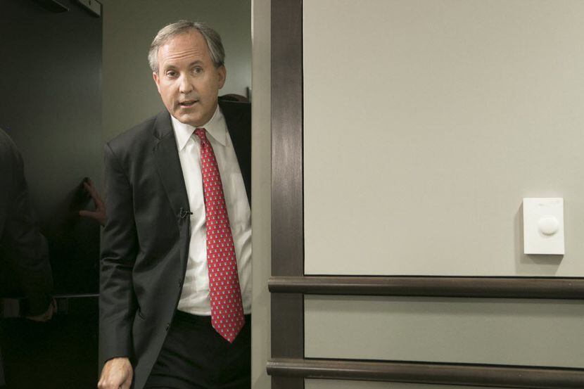 Republican Texas Attorney General Ken Paxton arrives at a news conference in Austin where he...