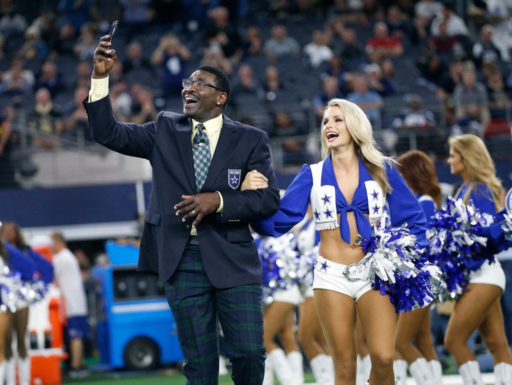 Former Dallas Cowboys wide receiver Michael Irvin shoots a video of himself being escorted...