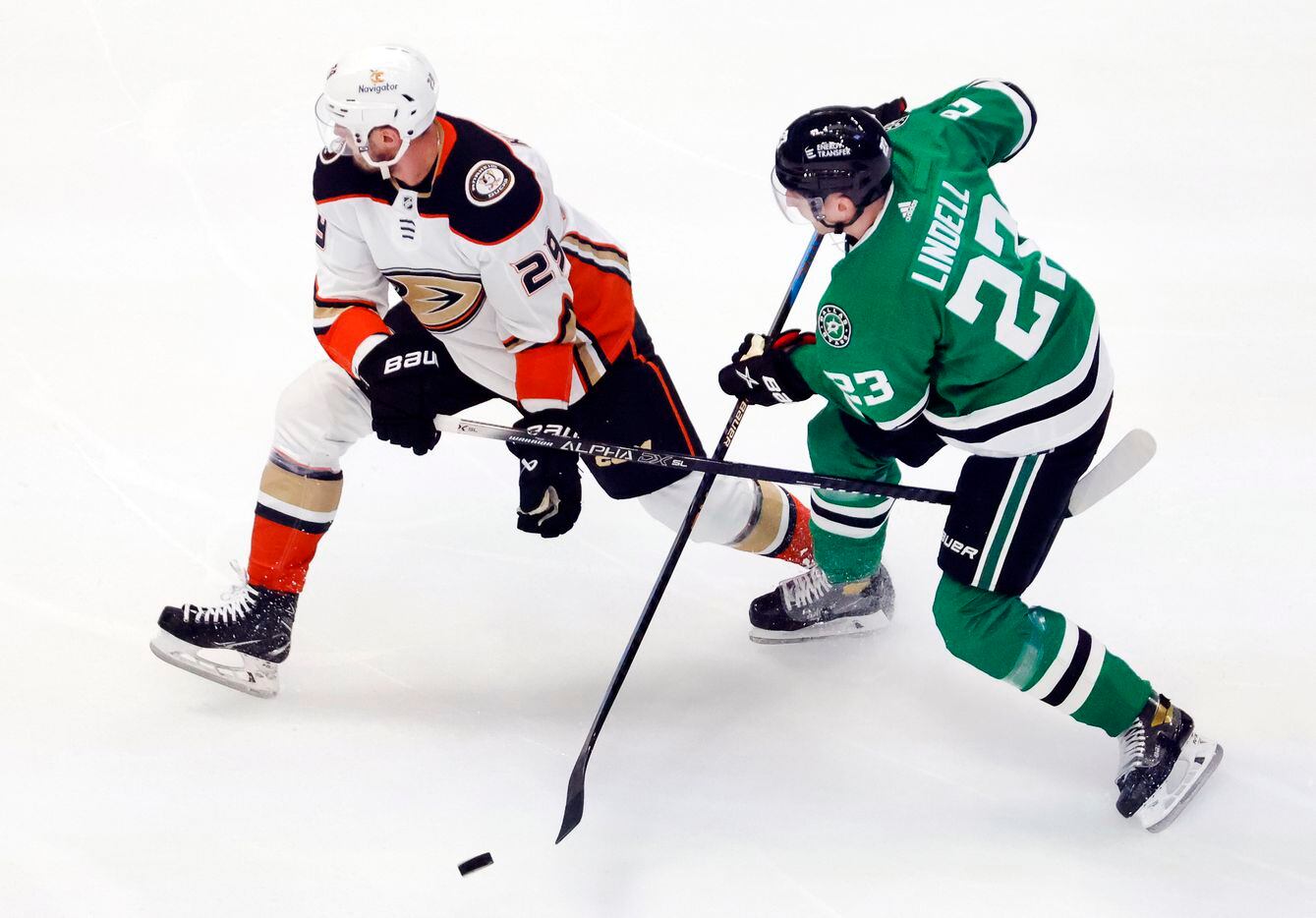 Dallas Stars defenseman Esa Lindell (23) and Anaheim Ducks defenseman Dmitry Kulikov (29)...