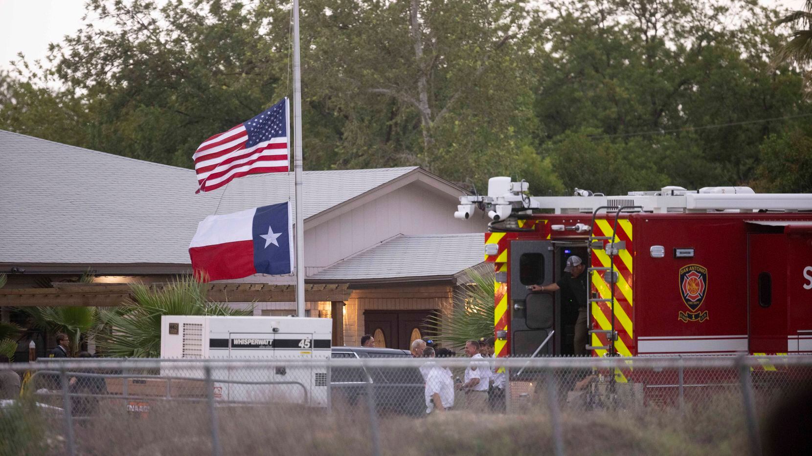 Flags fly at half-staff outside of Robb Elementary School after 14 children and one teacher...