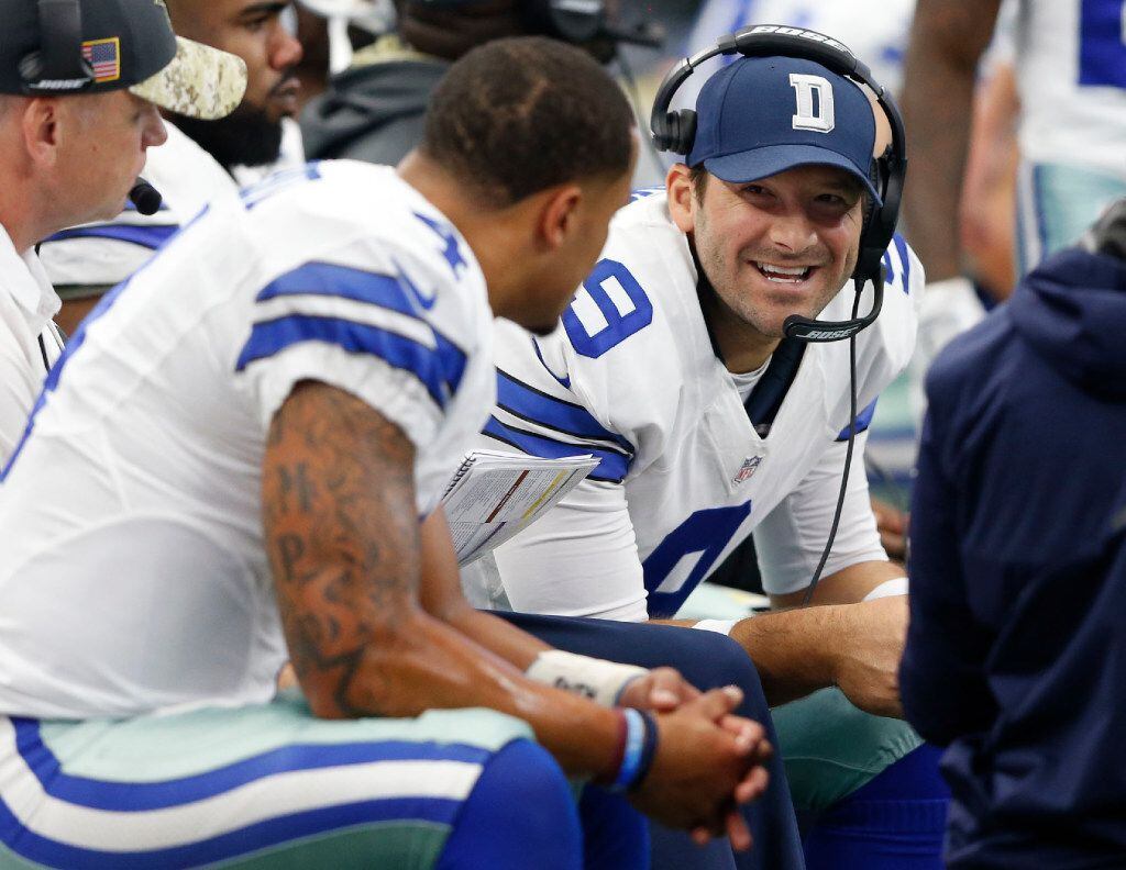 Dallas Cowboys quarterback Tony Romo (9) talks to Dallas Cowboys quarterback Dak Prescott on...