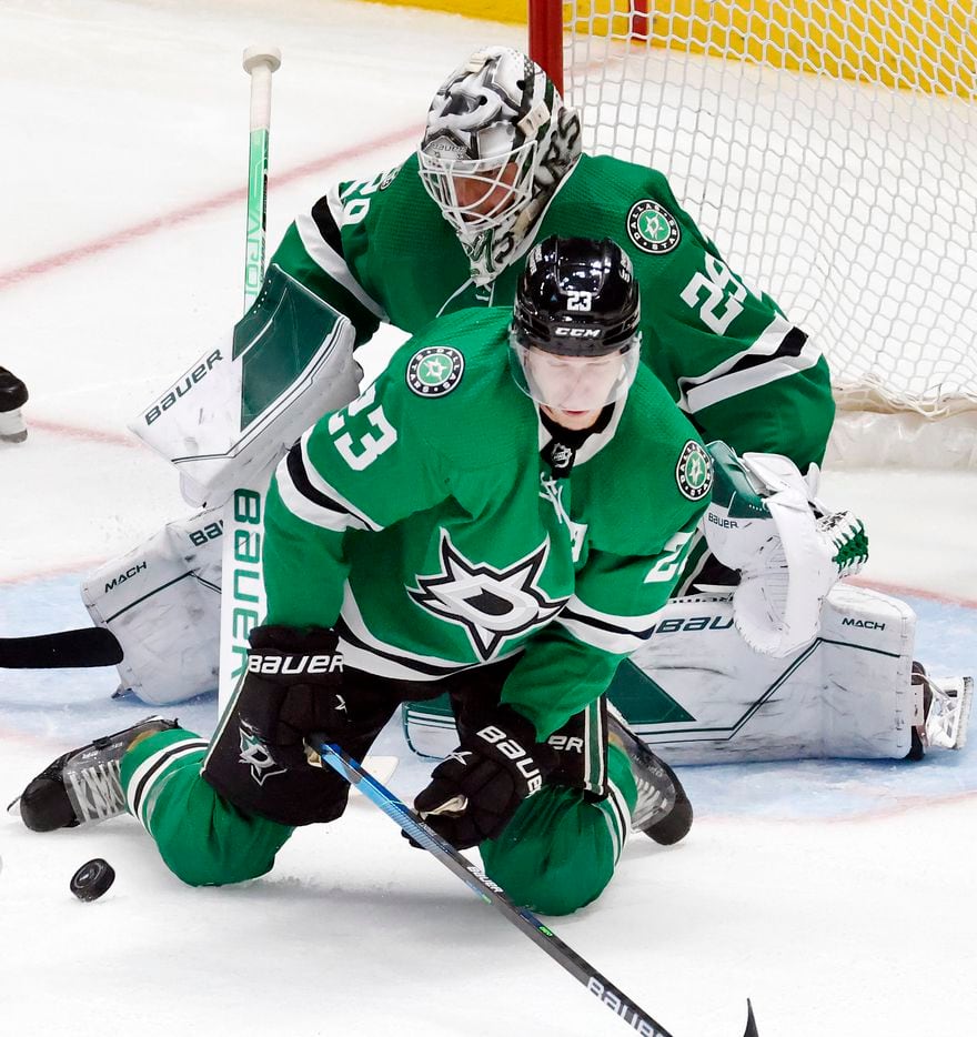 Dallas Stars defenseman Esa Lindell (23) stops a shot by the Calgary Flames during a second...