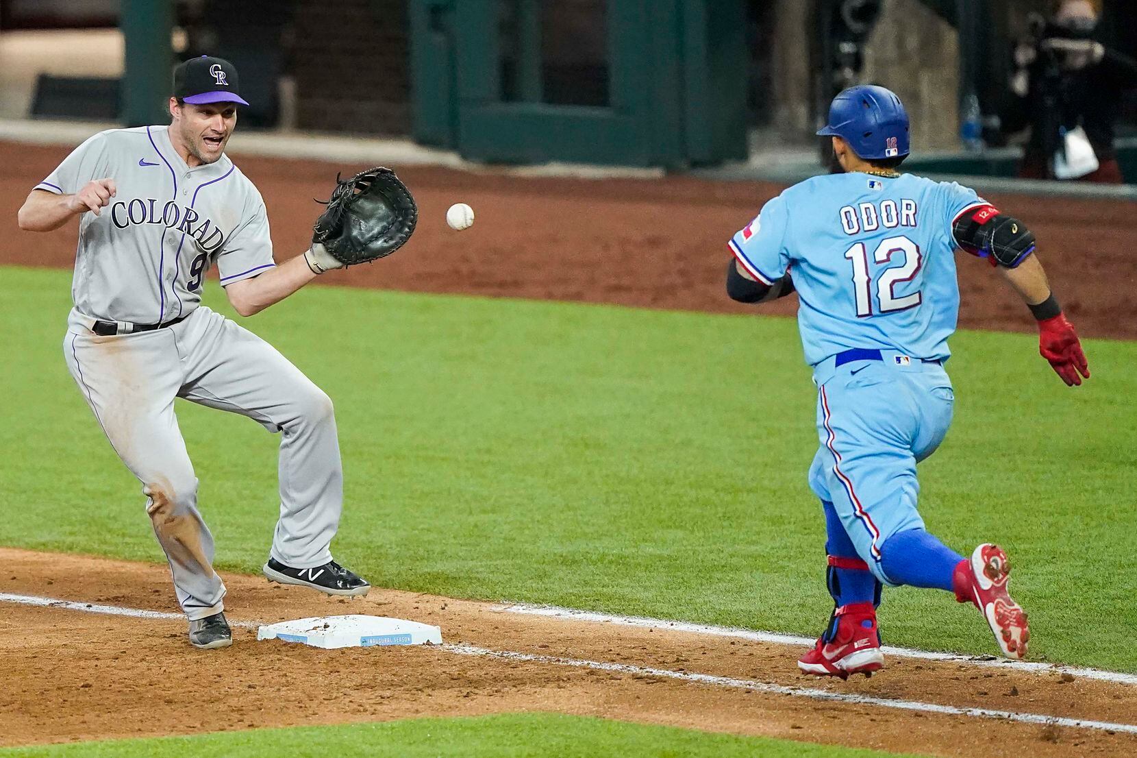 Texas Rangers second baseman Rougned Odor is out at first as Colorado Rockies first baseman...