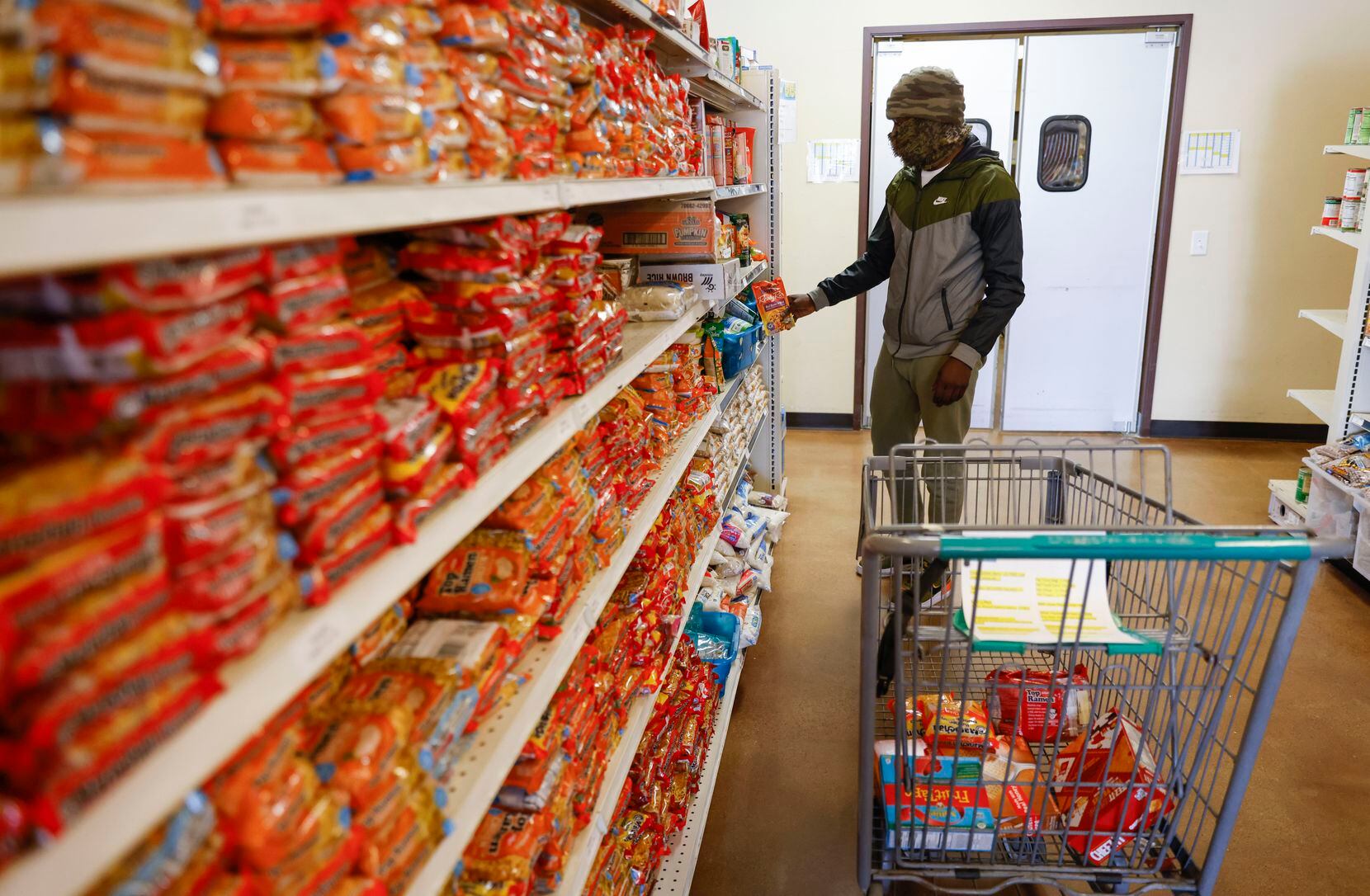 Frisco resident Pete Sanders grabs some ramen noodles while shopping at Frisco Family Services on Thursday, Feb. 10, 2022. 