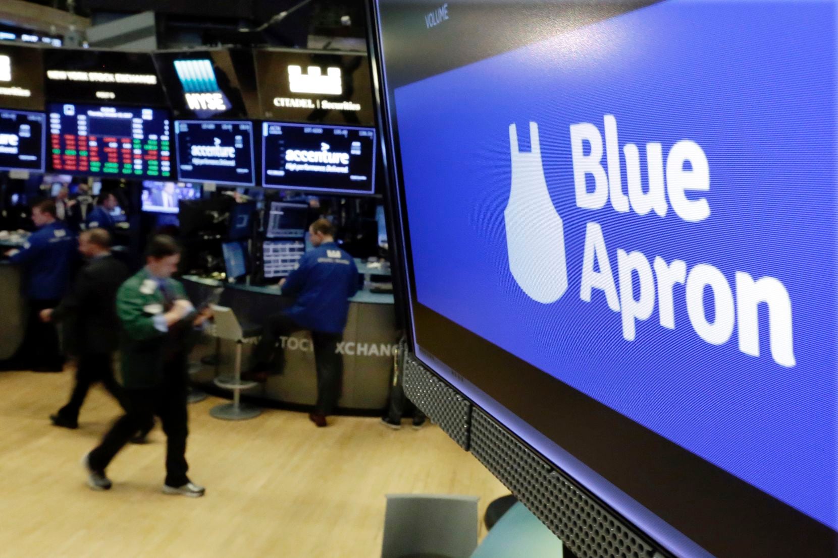 The logo for Blue Apron appears on a screen above the trading floor of the New York Stock Exchange in a 2017 file photo.