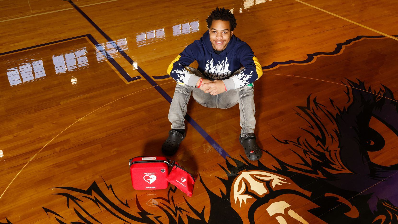 Kamathi Long sits next to a defibrillator on Tuesday, Jan. 10, 2023, in the gym where Long...