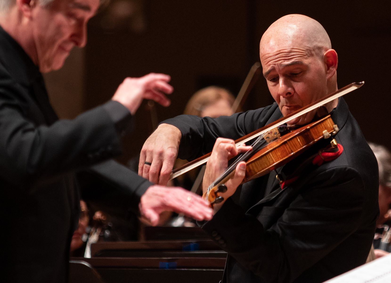 Concertmaster Alexander Kerr, right, plays violin as James Conlon conducts the Dallas...