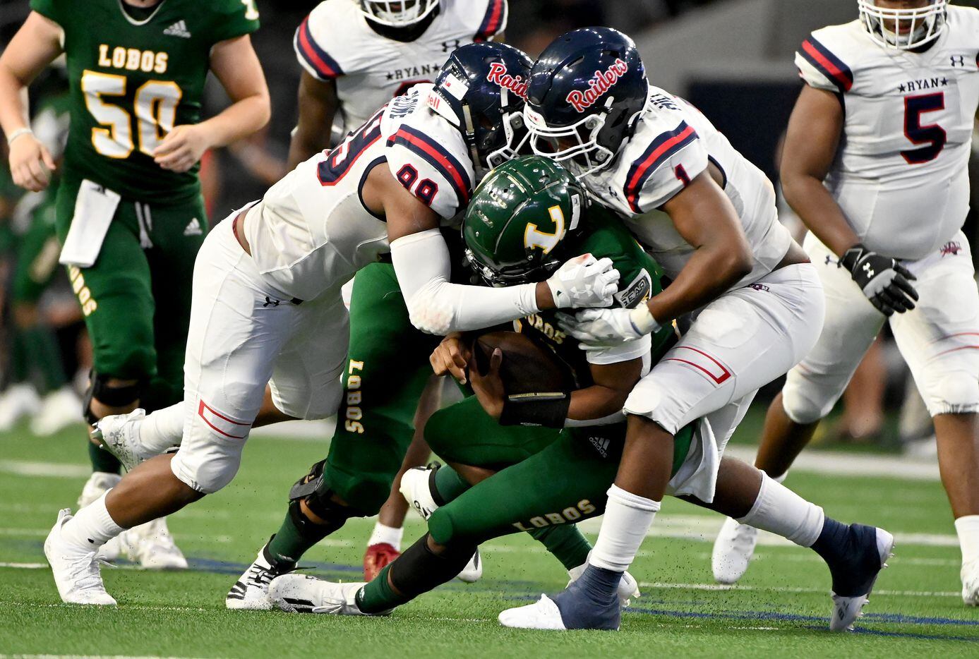 Denton Ryan’s Ravonte Blowe (99) and MarQuice Hill II (1) sack Longview quarterback Jordan Allen in the second half during a high school football game between Longview and Denton Ryan, Saturday, Aug. 28, 2021, in Frisco, Texas. Denton Ryan won 40-7. (Matt Strasen/Special Contributor)