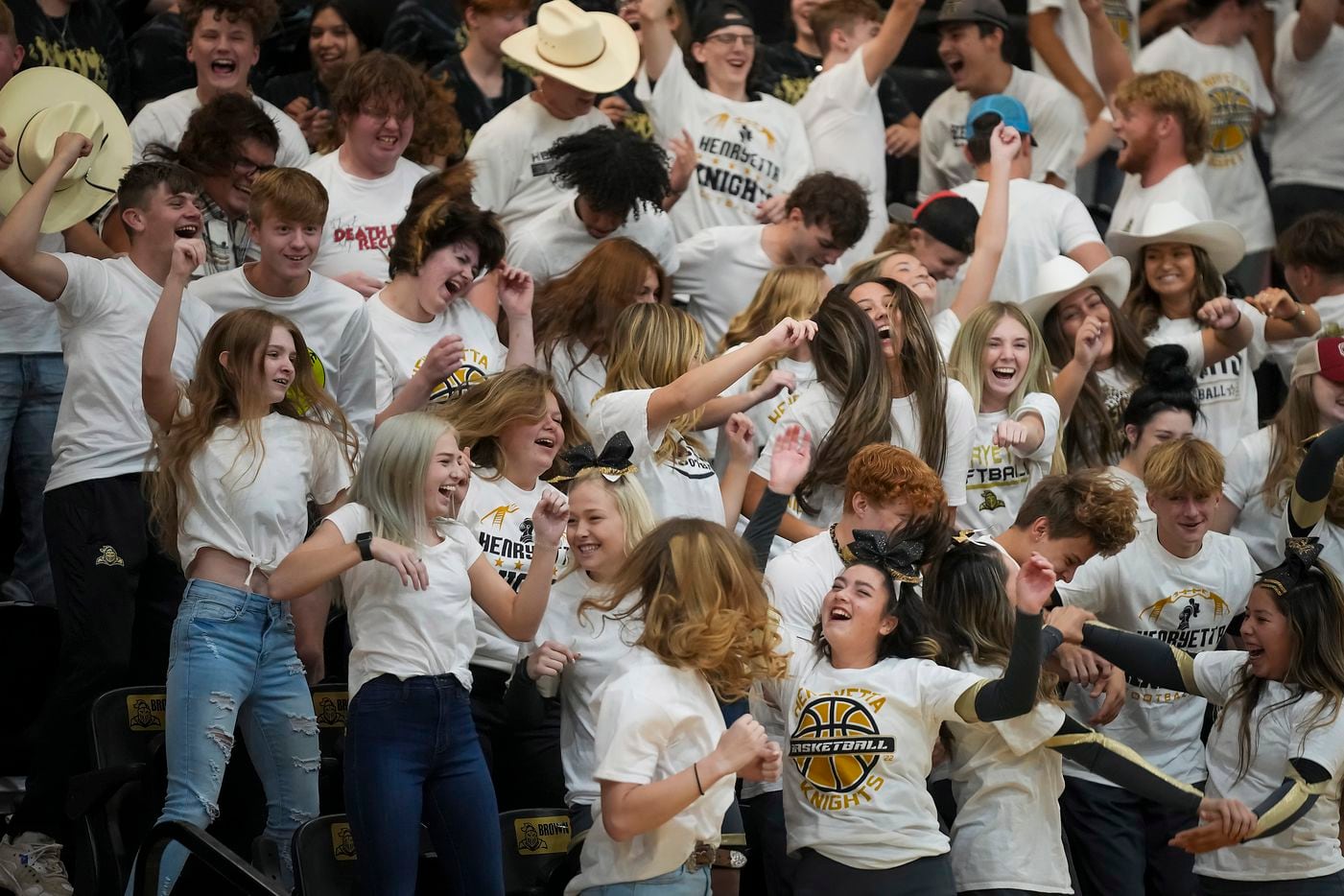 Students cheer during a performance in honor of special surprise guest Troy Aikman during a pep rally at Henryetta High School on Friday.