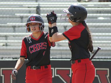 Colleyville Heritage second baseman Leah Perales (5) high fives catcher Alexis Perales (3) after the game-winning run during a softball Class 5A area-round playoff game against Mansfield Legacy in Colleyville, Texas on Saturday, May 8, 2021.