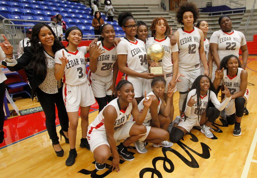 Cedar Hill coach Nicole Collins poses with her team following a 65-57 overtime victory over...