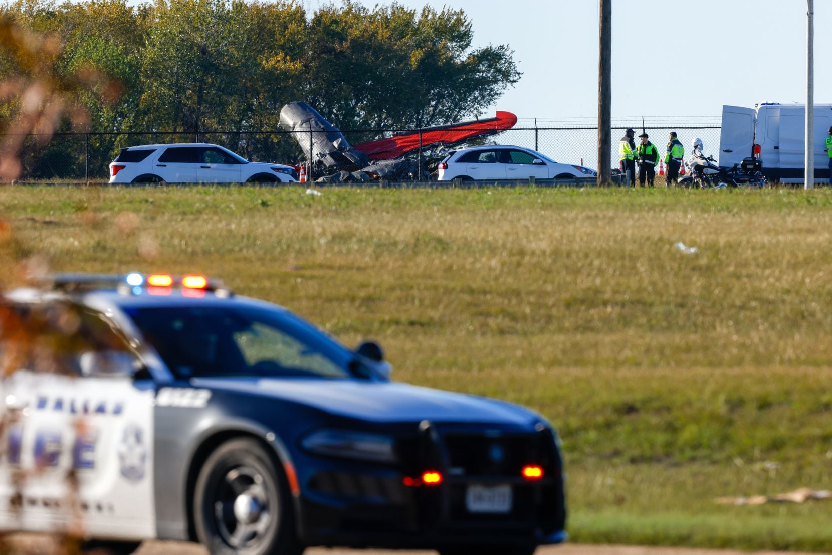 Firefighters and police respond to a midair collision between two planes at Dallas Executive...