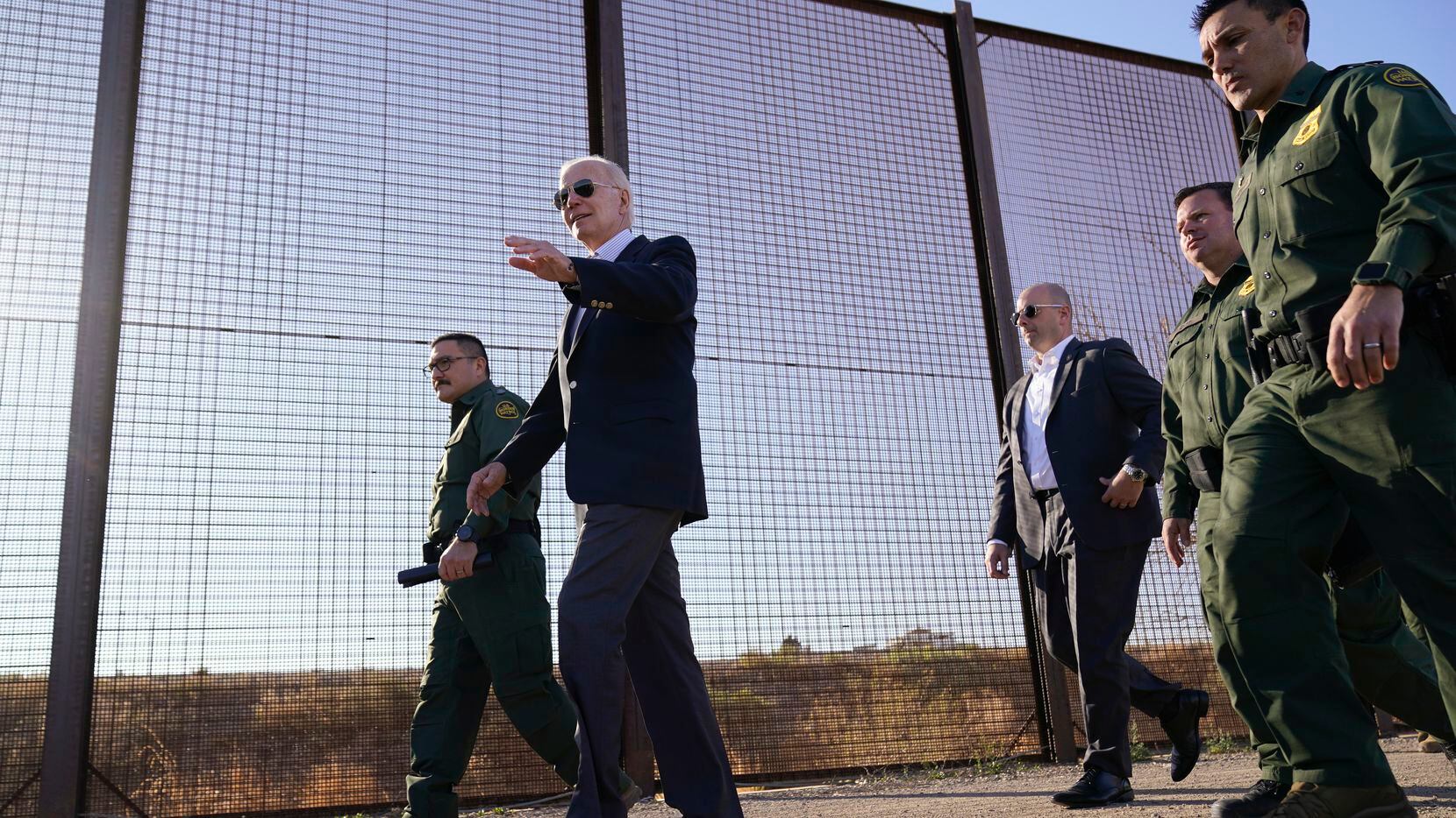 FILE - President Joe Biden walks along a stretch of the U.S.-Mexico border in El Paso Texas,...